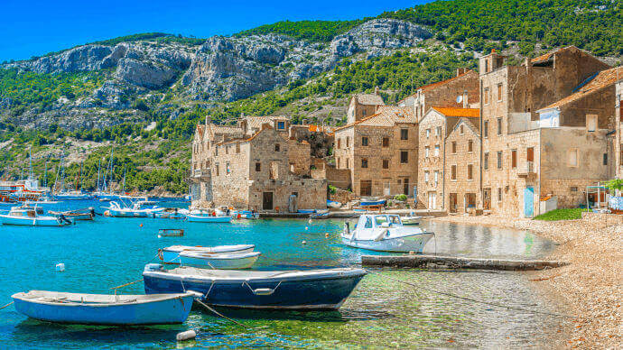 Scenic view of Komiza village from a beach on the Blue Cave & Hvar Tour from Split