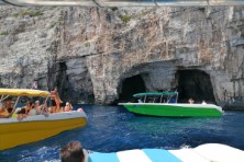 Boats entering in front of the cave during Blue Cave & Hvar Tour from Split