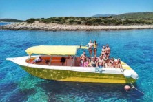Yellow speedboat cruising near islands on Split excursion