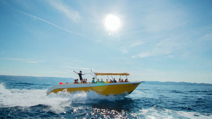 Blue Cave & Hvar Tour from Split on a yellow speedboat with tourists visiting Croatian islands